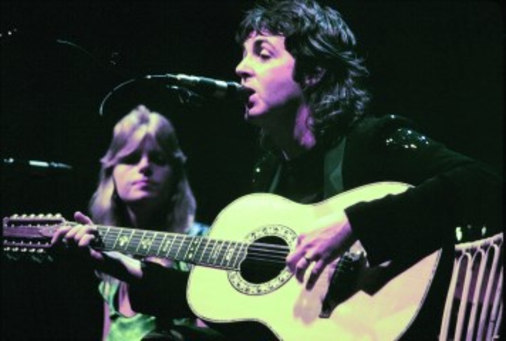 Paul McCartney performs in 1976, with his wife Linda (now deceased). /Jim Summaria via Wikimedia Commons